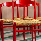 Eight 1970s red Italian dining chairs in the style of Gio Ponti